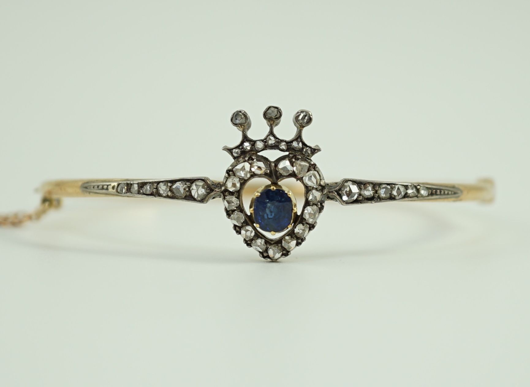 A 19th century gold, sapphire and rose cut diamond set hinged bangle
